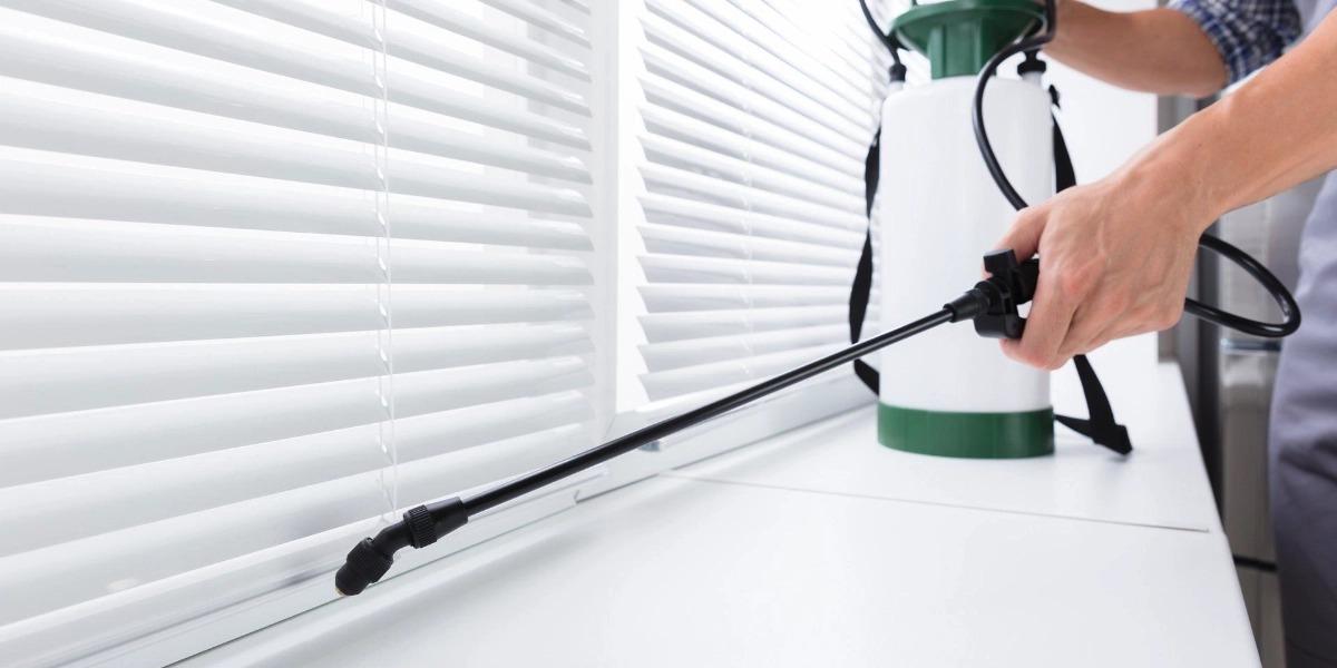 Affordable Pest Control technician treating a Rexburg home for cockroaches